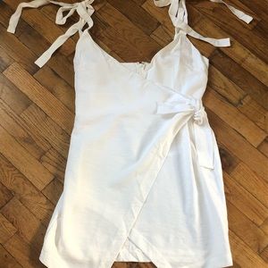 White wrap dress with adjustable shoulder straps.